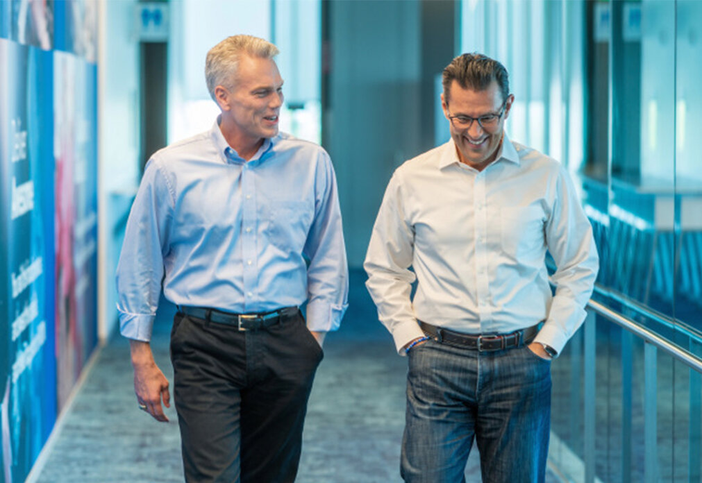 Brad Smith and Sasan Goodarzi walking down hallway