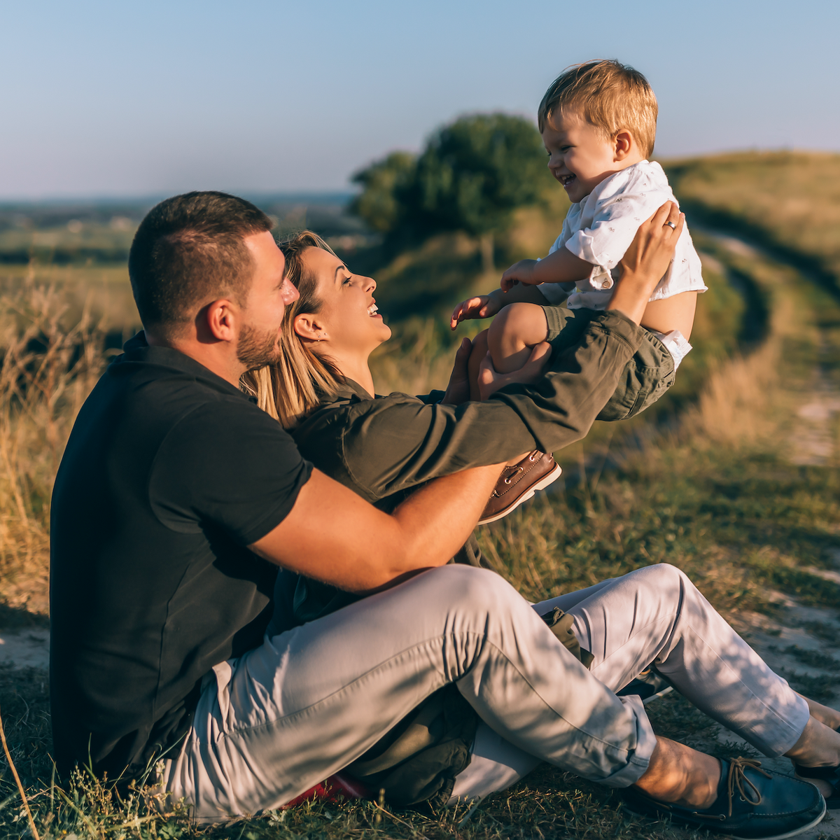  2021/12/Smiling_young_family_playing_outdoors.png 