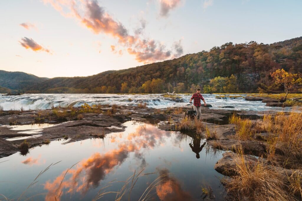 A man walks his dog through the Appalachian Mountains in West Virginia.